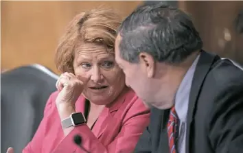  ?? J. Scott Applewhite/Associated Press ?? Democratic Sens. Heidi Heitkamp and Joe Donnelly listen Tuesday on Capitol Hill as the Senate Banking Committee holds a hearing on sanctions against Russia.