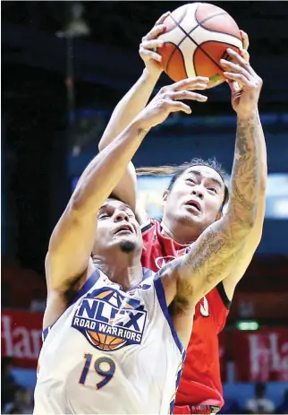  ??  ?? Kia’s Jay-R Reyes, back, picks off the rebound from behind NLEX's Rabeh Al-Hussaini during Wednesday night’s PBA Philippine Cup game at the F iloil Flying V Centre in San Juan. (Rio Leonelle Deluvio)