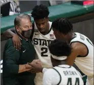  ?? CARLOS OSORIO - STAFF, AP ?? Michigan State coach Tom Izzo talks to guard Rocket Watts (2) and forward Aaron Henry during the second half of the team’s NCAA college basketball game against Detroit Mercy, Friday, Dec. 4, 2020, in East Lansing, Mich.