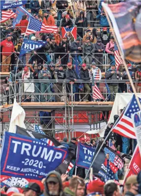  ?? JARRAD HENDERSON/USA TODAY ?? Pro-Trump rioters take over temporary risers built for Joe Biden's inaugurati­on at the U.S. Capitol on Jan. 6.