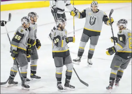  ?? Erik Verduzco Las Vegas Review-Journal @Erik_Verduzco ?? Silver Knights defenseman Jake Bischoff (45) celebrates with teammates after scoring in the second period of a 5-2 victory over the Ontario Reign at Orleans Arena on Saturday night.