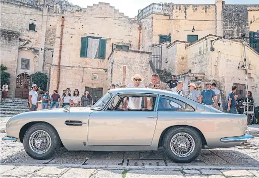  ?? NICOLA DOVE PHOTOS ?? Originally featured in “Goldfinger,” the Aston Martin DB5 makes a return to the James Bond franchise in “No Time to Die,” starring Daniel Craig, below.