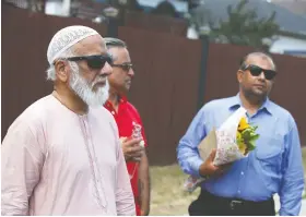  ??  ?? Imam Syed Soharwardy, left, says the two families involved in the overnight fire were members of the Green Dome Mosque in northeast Calgary,