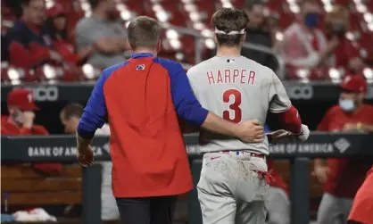  ?? Photograph: Joe Puetz/AP ?? Philadelph­ia Phillies right fielder Bryce Harper, right, is helped off the field after getting hit by a pitch during the sixth inning of Wednesday night’s game in St Louis.