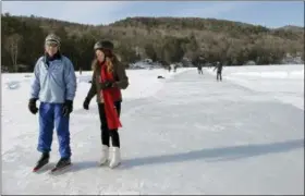  ?? LISA RATHKE — THE ASSOCIATED PRESS ?? In his photo, Stuart McDonald, left, of Center Harbor, N.H., and Judy Stoecklin, of Sanbornton, N.H., skate on Lake Morey in Fairlee, Vt., said to be the longest Nordic ice skating trail in the United States.