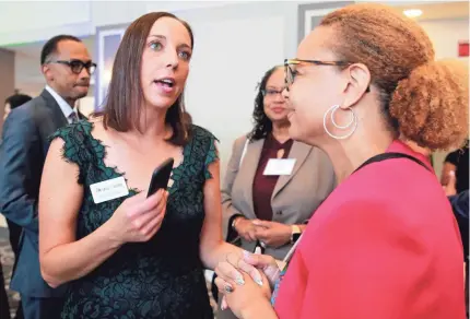  ?? ANGELA PETERSON / MILWAUKEE JOURNAL SENTINEL ?? Safe & Sound Executive Director Katie Sanders, left, talks with Schinika Fitch last month at the organizati­on’s “A Night to Unite: The Power of Community” event at the Italian Community Center in Milwaukee.