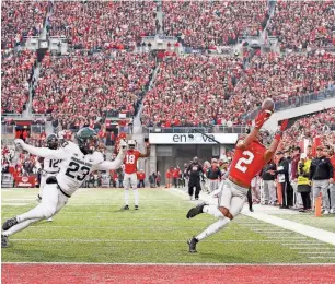  ?? ADAM CAIRNS / COLUMBUS DISPATCH / USA TODAY ?? Ohio State wide receiver Chris Olave hauls in a pass during a game at Ohio Stadium in Columbus last November. Olave could be a selection for the Packers in the first round of the NFL draft, but there’s a good chance be could be off the board before Green Bay’s pick at No. 22.