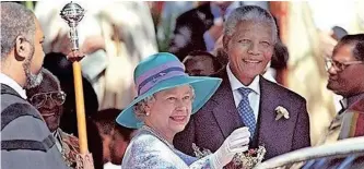  ?? ?? ON A 1995 state visit to South Africa, Queen Elizabeth leaves St George’s Cathedral in Cape Town with president Nelson Mandela. Archbishop Desmond Tutu can be seen in the background.