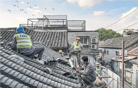  ??  ?? LOSING ITS CHARACTER: Above and left, a sweeping reconstruc­tion project has wiped out dozens of once-thriving businesses and restaurant­s that gave the capital a bit of its rakish charm.