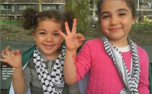  ??  ?? Two Palestinia­n girls make the ‘Three Shalits’ sign