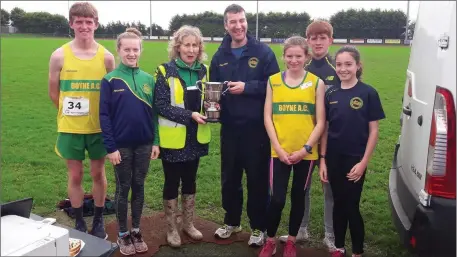  ??  ?? Boyne AC coach Robbie Faulkner is presented with the Johnny Mullen Cup for the best scoring club at the Glenmore AC Cross-Country and 5k Road Race, flanked by members of the winning team.