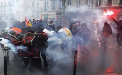  ??  ?? Flashpoint: Tear gas is used as protesters clash with police on the streets of Paris yesterday