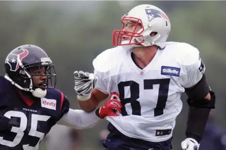  ?? CHRIS JACKSON/THE ASSOCIATED PRESS FILE PHOTO ?? Rob Gronkowski, eyeing a pass at a two-team practice, has missed 30 per cent of the Patriots’ regular-season games over the last five seasons.