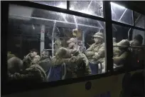  ?? THE ASSOCIATED PRESS ?? Ukrainian servicemen sit in a bus after leaving Mariupol's besieged Azovstal steel plant in Olyonivka in eastern Ukraine on Friday.