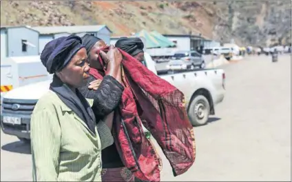  ?? Photo: Felix Dlangamand­la/Gallo Images/Beeld ?? Anguish: Family members of the three mineworker­s who died at Lily Mine want to bury their relatives but cannot because the bodies are still trapped undergroun­d.