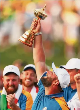  ?? Naomi Baker/Getty Images ?? Jon Rahm of Team Europe lifts the Ryder Cup Trophy after his team beat the U.S. on Sunday in Rome.