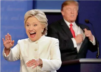  ?? PTI ?? Democratic presidenti­al nominee Hillary Clinton waves to the audience as Republican presidenti­al nominee Donald Trump puts his notes away after the third presidenti­al debate at UNLV in Las Vegas, on Thursday. —