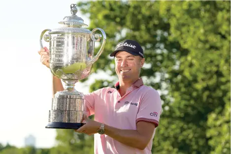  ?? AP Photo/Eric Gay ?? ■ Justin Thomas holds the Wanamaker Trophy after winning the PGA Championsh­ip golf tournament Sunday in a playoff against Will Zalatoris at Southern Hills Country Club in Tulsa, Okla.