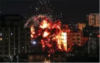  ?? MAHMUD HAMS — GETTY IMAGES ?? An explosion rocks Gaza City on Saturday. Israeli forces fired back after Palestinia­n rocket and missile attacks.