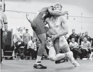  ?? JOHN SUDBRINK/FREELANCE FILE ?? Poquoson’s Jake Williams, right, tries to take down John Marshall’s Deandre Louis-Jean in the 152-pound weight class at last season’s Class 2 Region A wrestling tournament at Poquoson High School.