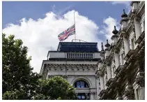  ?? STEFAN ROUSSEAU / PA ?? The Union flag flies at half mast at Whitehall in central London on Sunday, after Saturday night’s terrorist incident. Prime Minister Theresa May has called on internet companies to do more to block extremist groups who use the web to recruit members...