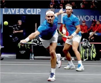  ?? — AP ?? Team Europe’s Roger Federer reaches for a shot as doubles partner Rafael Nadal looks on, in their Laver Cup match against Team World’s Jack Sock and Sam Querrey in Prague. Federer-Nadal won 6-4, 1-6, 10/5.