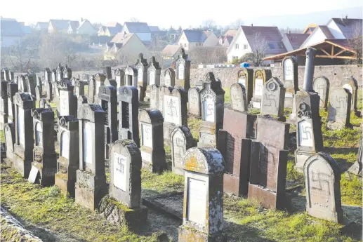  ?? (Reuters) ?? GRAVES DESECRATED with swastikas are seen at the Jewish cemetery in Westhoffen, near Strasbourg, France.