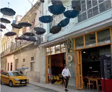  ??  ?? A taxi arrives at a private restaurant in Havana. On December 7, a package of measures aimed at “reordering” the Cuban private sector will come into force, but many self-employed people fear more control by the State. — AFP photo