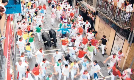 ?? RICK STEVES ?? The Running of the Bulls takes place annually in Pamplona, Spain.