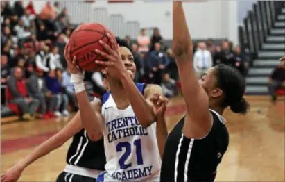  ?? JOHN BLAINE — FOR THE TRENTONIAN ?? Trenton Catholic’s Jada Queen, left, tries to score the ball while being defended by Rutgers Prep’s Olivia Mullins, right, during the Non-Public B South final on Tuesday night.