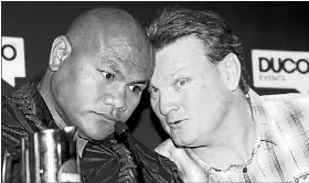  ?? Photo: John Selkirk ?? Getting cosy: Duco’s corporate salesman Dean Lonergan gets up close and personal with boxer David Tua at the rare open sparring session.