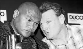  ?? Photo: John Selkirk ?? Getting cosy: Duco’s corporate salesman Dean Lonergan gets up close and personal with boxer David Tua at the rare open sparring session.