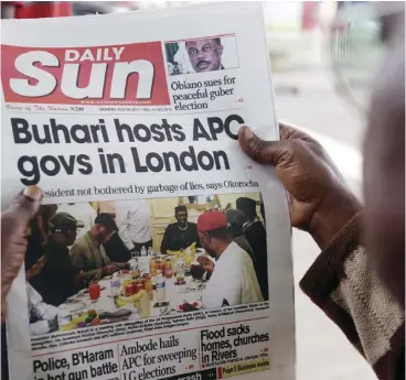  ?? AP Photo/sunday alamba, FIlEs ?? A man in Lagos reads a story about Nigeria’s President Buhari. In Nigeria and some other African countries, fake news can lead to retaliator­y killings.