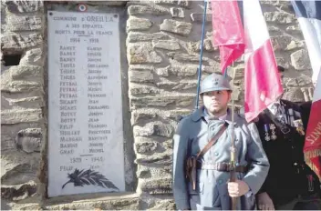  ?? — AFP ?? A man dressed as a French soldier of the World War I stands guard in front of a monument in tribute to the fallen soldiers at the cemetery of Oreilla in southweste­rn France. The village of the Pyrenees, Oreilla, holds the record of the French city with the highest per cent of people killed during the WWI in proportion to its population. Thirteen per cent of the inhabitant died.