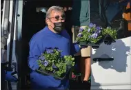  ?? SUBMITTED PHOTO ?? Bill Reynolds of Pratt’s Greenhouse unloads flowers for the Kennett Blooms beautifica­tion project this spring.