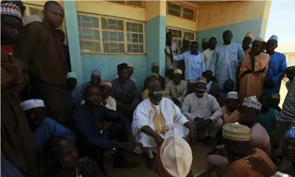  ?? Photograph: Afolabi Sotunde/Reuters ?? Parents gather at the Government Science school after Friday’s attack.