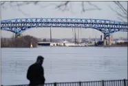  ?? MATT ROURKE - THE ASSOCIATED PRESS ?? A person walks past the Interstate-95′s mile-long doubledeck­ed Girard Point Bridge in Philadelph­ia, Wednesday, Feb. 24, 2021. PennDOT named several bridges including the Girard Point Bridge that it said it is considerin­g tolling to pay for the reconstruc­tion.