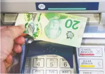  ?? RYAN REMOIRZ/THE CANADIAN PRESS ?? Going to the ATM to get cash is quickly becoming a thing of the past as society shifts to other ways to pay.