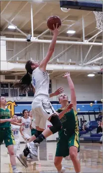  ??  ?? Leland ‘s Ericka Sangco-lidgey (5) splits two Leigh defenders for a layup in the Chargers’ victory.