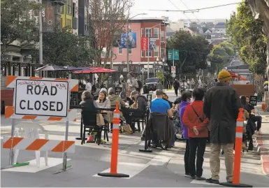  ?? Jeff Chiu / Associated Press ?? Restaurant patrons eat outside in S. F., which will still allow outdoor dining if it moves into the purple tier.