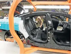  ?? /Reuters ?? Duty relief: A Chrysler employee works on the assembly line at the Canadian assembly plant in Brampton.