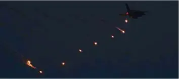  ?? Abdul Rahman/Gulf News ?? A fighter jet drops a series of flares during the military drill in Abu Dhabi yesterday.