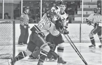  ??  ?? Jake Martin of the Pictou County Crushers battles with Ryan Semple of the Yarmouth Mariners on Jan. 3.