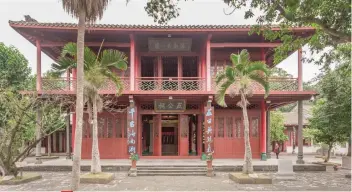  ??  ?? FIVE LORDS ANCESTRAL HALL. Considered the very first building in Hainan, the red two-storey wooden structure was erected during the Ming Dynasty.