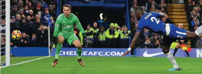  ??  ?? Head boy: Chelsea centre half Antonio Rudiger scores the only goal at Stamford Bridge, stooping to head past a static Lukasz Fabianski in the Swansea goal