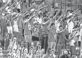  ?? CHUCK BURTON/AP ?? Texas Longhorns fans sing “The Eyes Of Texas” after a game.