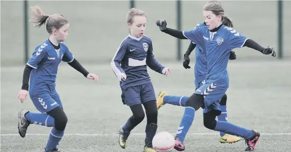  ??  ?? Russell Foster Mini Soccer Under-10s Winter League action between Durham RTC Girls and Washington AFC Lions (navy), played at Riverside, Chester-le -Street.