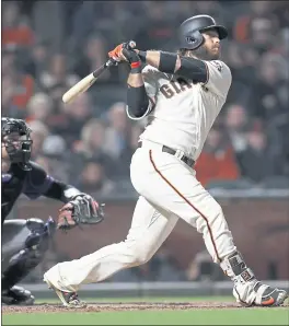  ?? NHAT V. MEYER — STAFF PHOTOGRAPH­ER ?? The Giants’ Brandon Crawford connects on a walk-off home run to beat the Colorado Rockies 1-0 at AT&amp;T Park on Wednesday night.