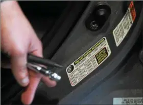  ?? KRISTI GARABRANDT — THE NEWS-HERALD ?? For motorist wanting to know how much air to put in their tires, checking the label inside the driver’s door should provide that answer along with additional tire informatio­n.
