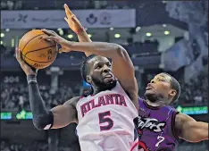  ?? ASSOCIATED PRESS ?? FRANK GUNN DeMarre Carroll of the Hawks looks to pass around Raptors defender Kyle Lowry.